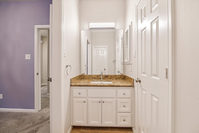 bathroom with vanity and baseboards