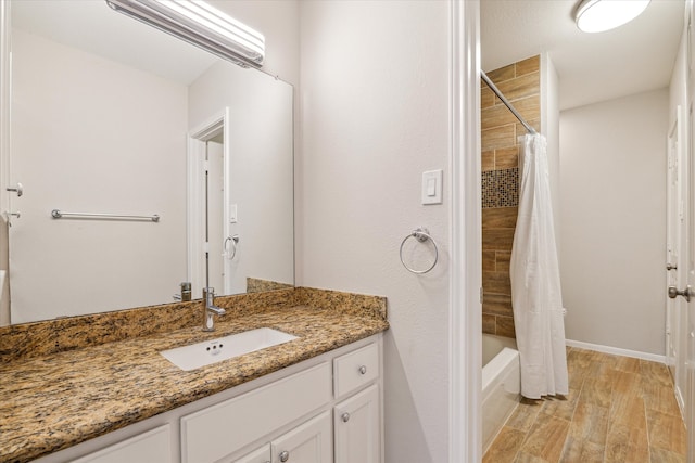 full bath featuring shower / tub combo, vanity, and wood finished floors