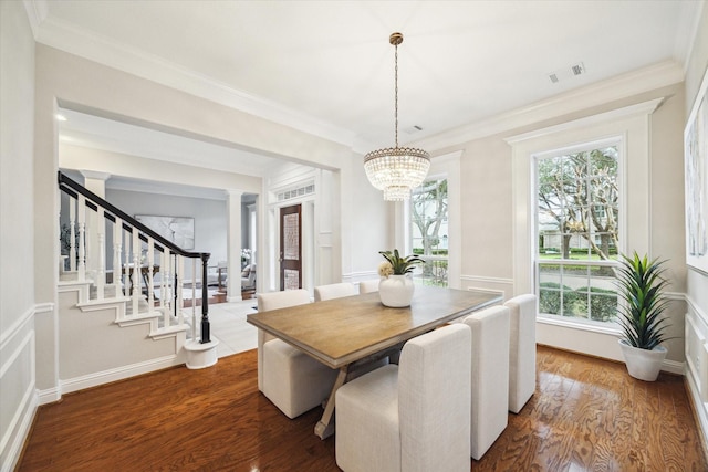 dining area featuring stairway, wood finished floors, visible vents, and crown molding