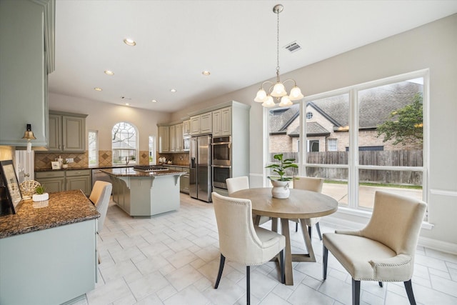 dining area with a chandelier, recessed lighting, and visible vents