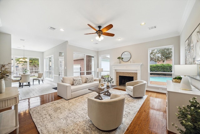 living room featuring wood finished floors, visible vents, and a healthy amount of sunlight