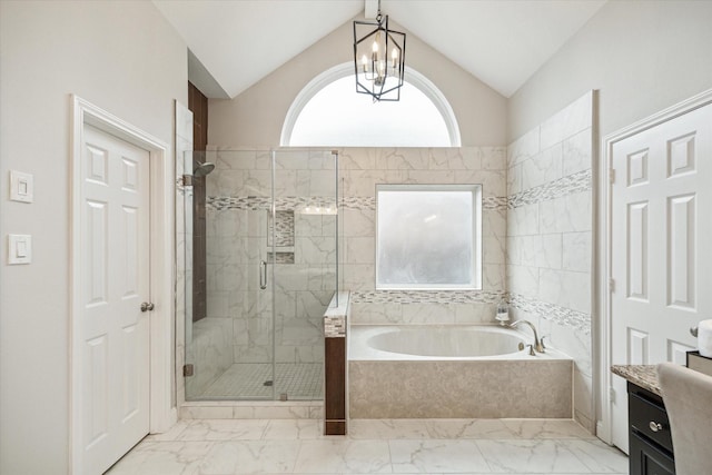 bathroom featuring a stall shower, lofted ceiling, marble finish floor, and a bath