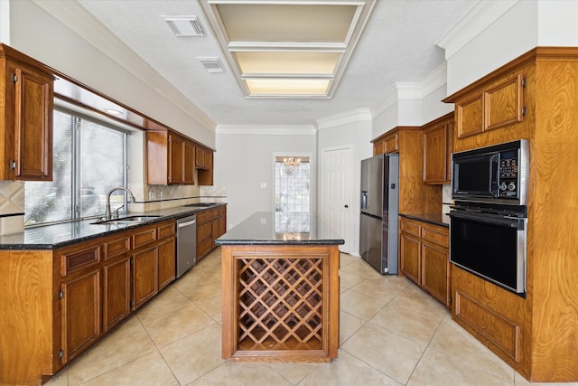 kitchen featuring sink, appliances with stainless steel finishes, backsplash, crown molding, and a kitchen island