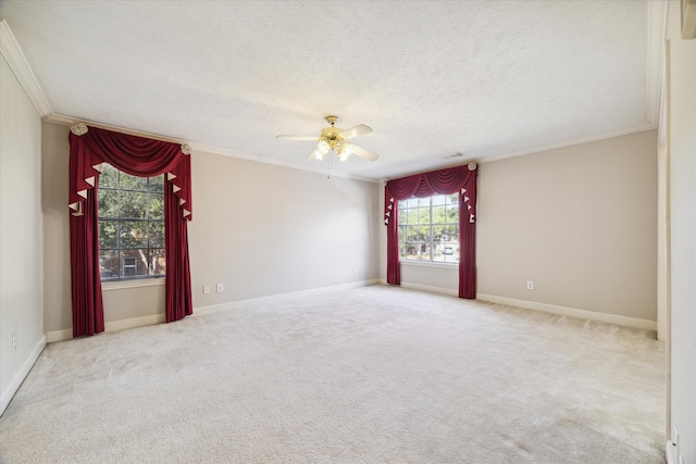 carpeted empty room with a textured ceiling, ceiling fan, and crown molding