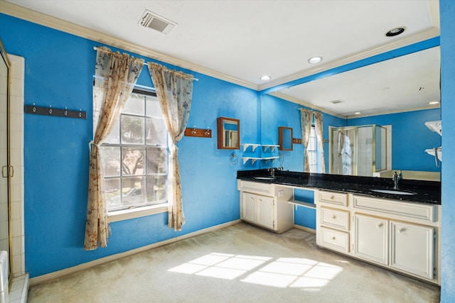 bathroom with ornamental molding, vanity, and a shower with door