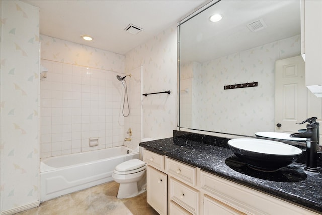 full bathroom with toilet, tiled shower / bath combo, and vanity