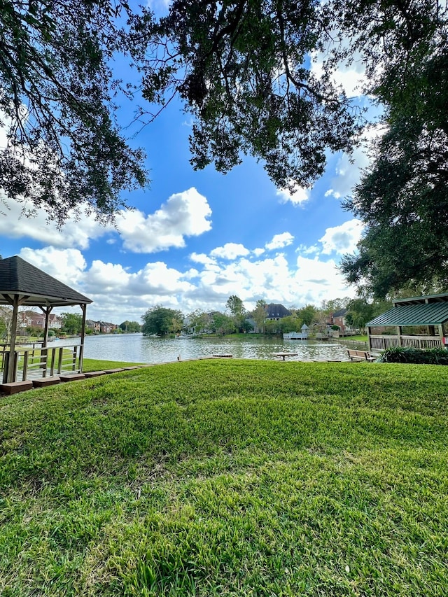 view of yard featuring a gazebo and a water view