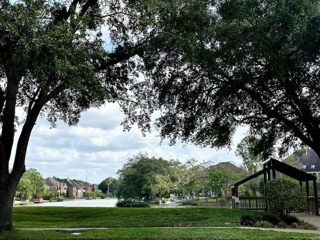 exterior space with a water view and a lawn