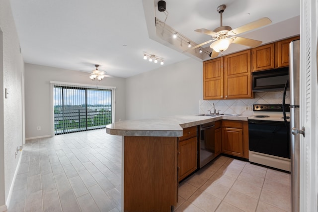 kitchen featuring electric stove, track lighting, decorative backsplash, stainless steel dishwasher, and kitchen peninsula