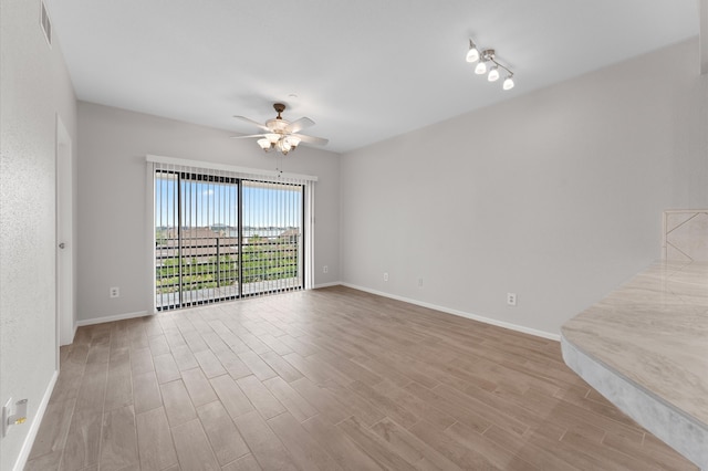 unfurnished room with light wood-type flooring, ceiling fan, and rail lighting