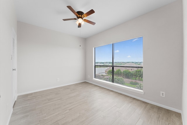 spare room with light wood-type flooring and ceiling fan