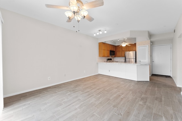 unfurnished living room with light hardwood / wood-style flooring and ceiling fan