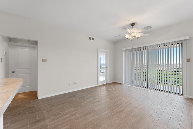 empty room featuring hardwood / wood-style flooring and ceiling fan