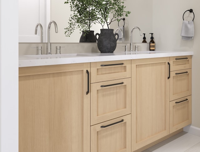 kitchen with light brown cabinetry, sink, and light tile patterned flooring