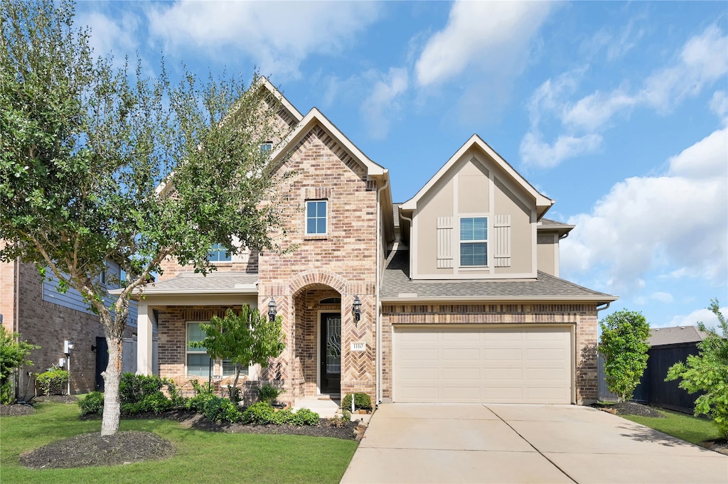 view of front of property with a garage and a front yard