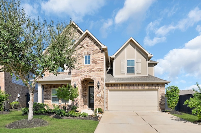 view of front of property with a garage and a front yard