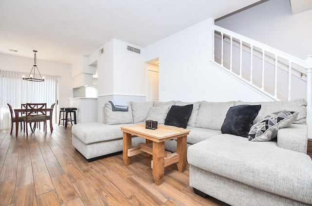 living room featuring hardwood / wood-style floors and a notable chandelier