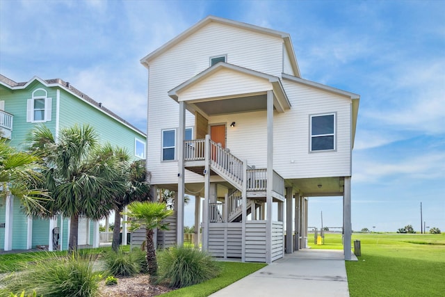 coastal inspired home with a porch and a front yard