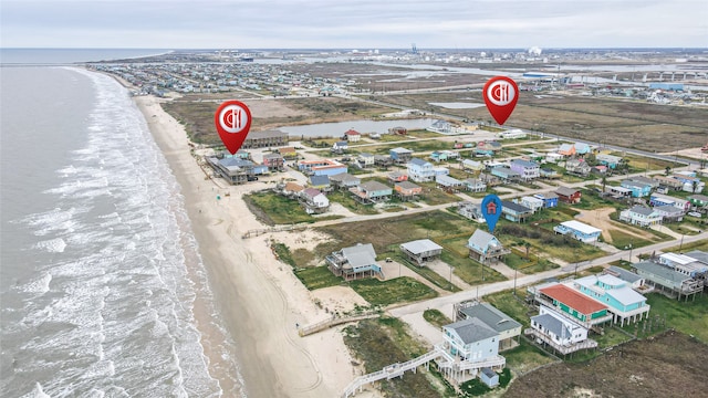 bird's eye view featuring a water view and a beach view