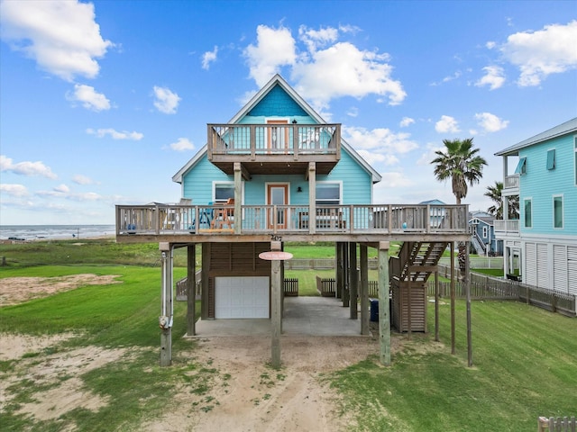 view of front of house featuring a front lawn, a deck with water view, a carport, and a garage