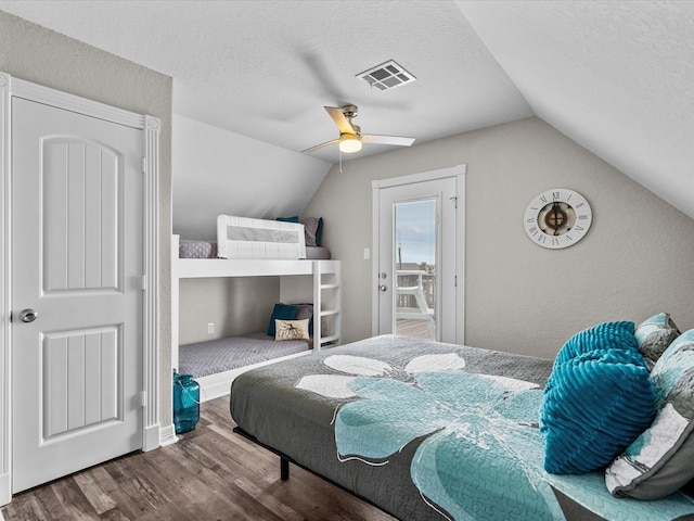 bedroom featuring a textured ceiling, ceiling fan, vaulted ceiling, and hardwood / wood-style flooring