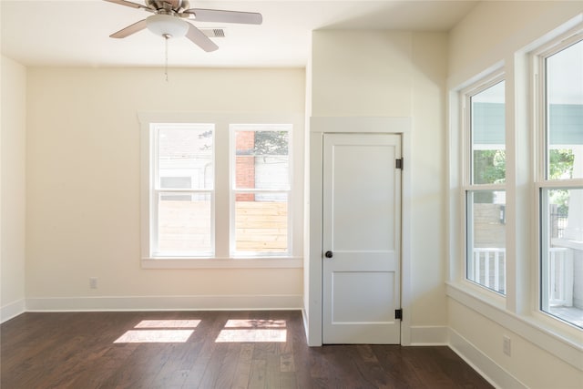 unfurnished room featuring dark wood-type flooring and ceiling fan