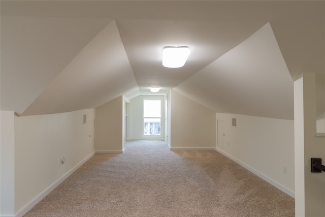 bonus room featuring light carpet and lofted ceiling