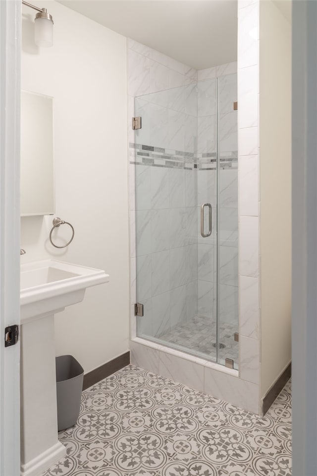 bathroom featuring a shower with door and tile patterned flooring