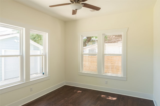 unfurnished room with plenty of natural light, ceiling fan, and dark hardwood / wood-style flooring