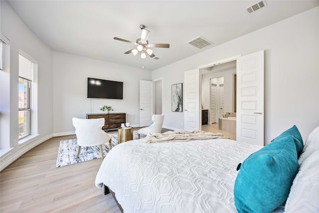 bedroom with ensuite bath, light hardwood / wood-style flooring, and ceiling fan