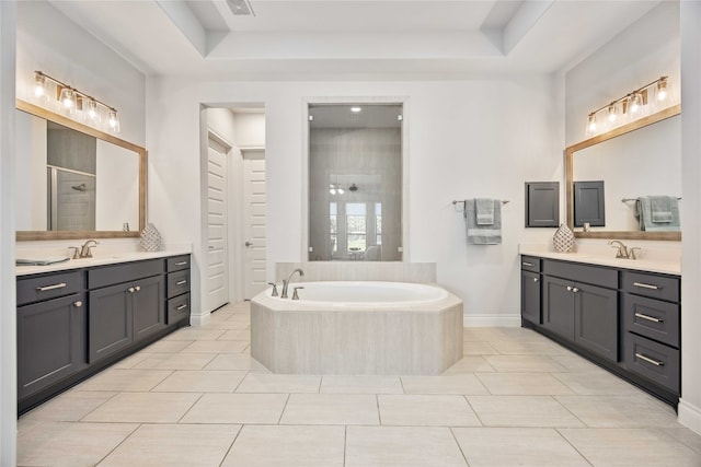 bathroom featuring vanity, shower with separate bathtub, and a raised ceiling