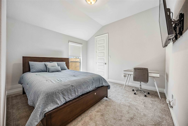 carpeted bedroom with lofted ceiling