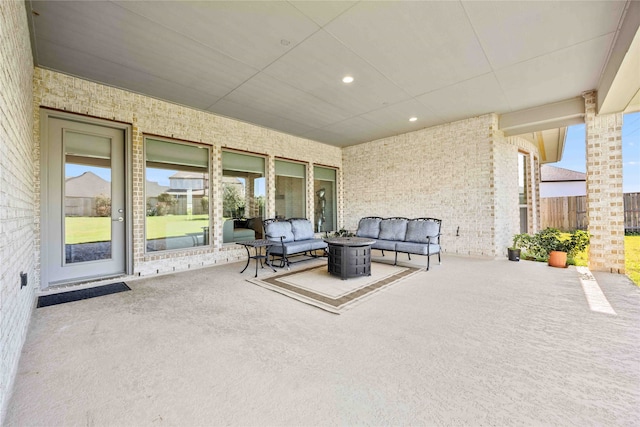 view of patio featuring an outdoor living space with a fire pit