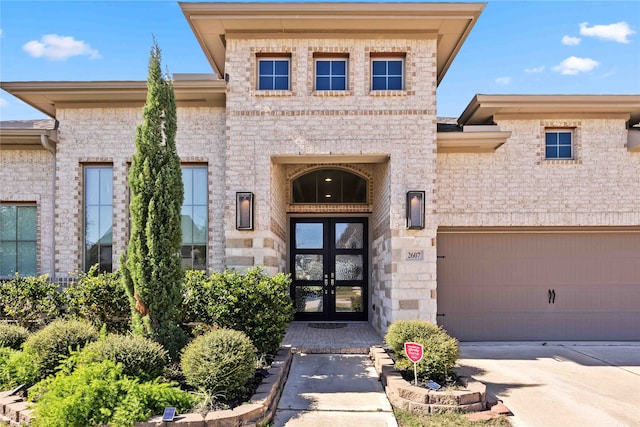 entrance to property featuring french doors and a garage