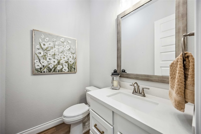 bathroom with vanity, wood-type flooring, and toilet