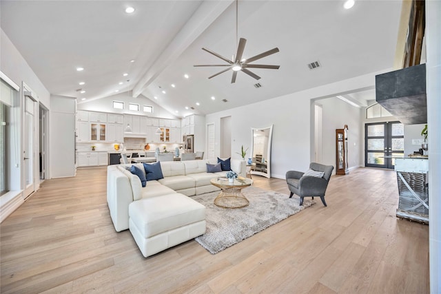 living room featuring french doors, high vaulted ceiling, light hardwood / wood-style flooring, beamed ceiling, and ceiling fan