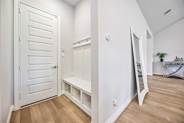 mudroom with vaulted ceiling and light wood-type flooring