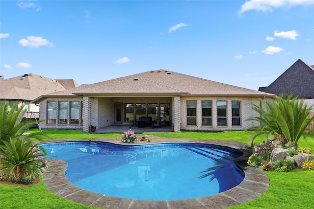 view of swimming pool featuring a patio and a lawn