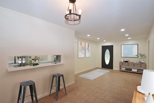 entrance foyer with a chandelier and light tile patterned floors