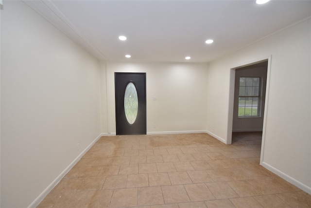 tiled foyer entrance featuring ornamental molding