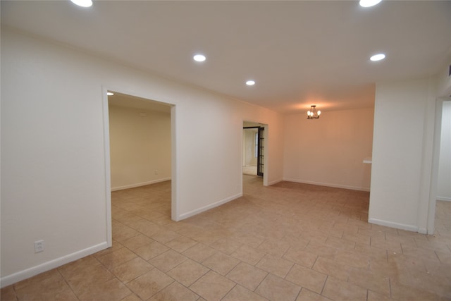 spare room featuring a notable chandelier