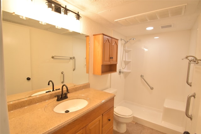 bathroom featuring walk in shower, toilet, vanity, and tile patterned floors