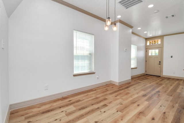 foyer with light hardwood / wood-style flooring and ornamental molding