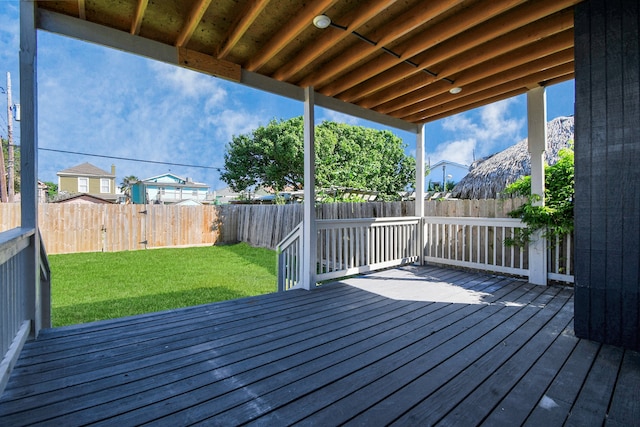 wooden terrace featuring a lawn