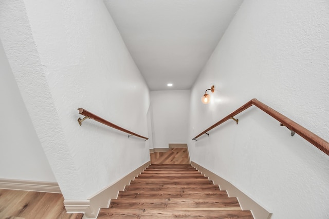 stairs featuring wood-type flooring