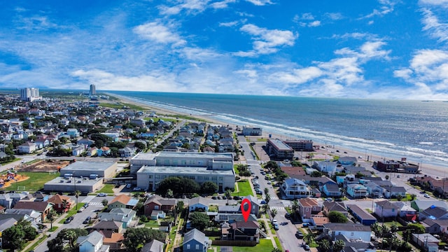 bird's eye view featuring a water view and a beach view