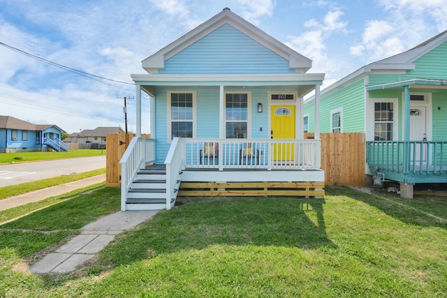 bungalow-style home featuring a front lawn and covered porch