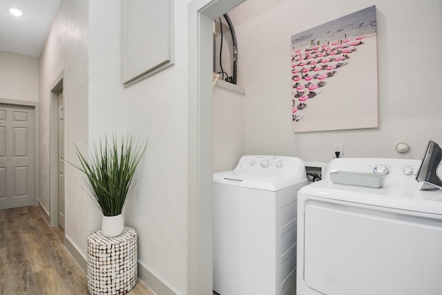 laundry area with hardwood / wood-style flooring and separate washer and dryer