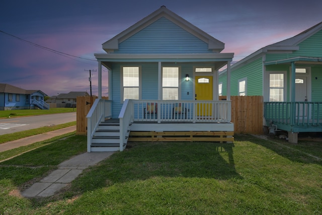 bungalow featuring a yard and covered porch