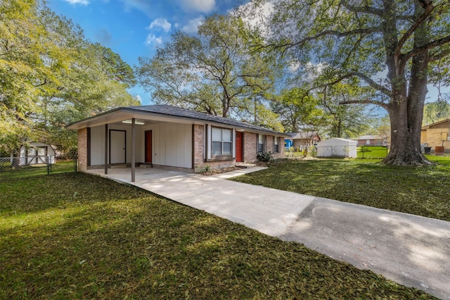 view of front of property featuring a patio area, a front yard, and a storage shed